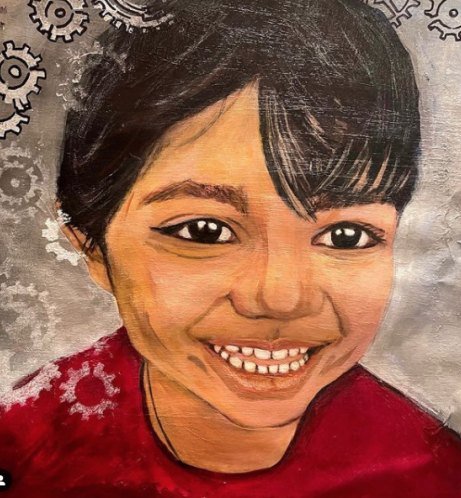 A laughing child in a red top