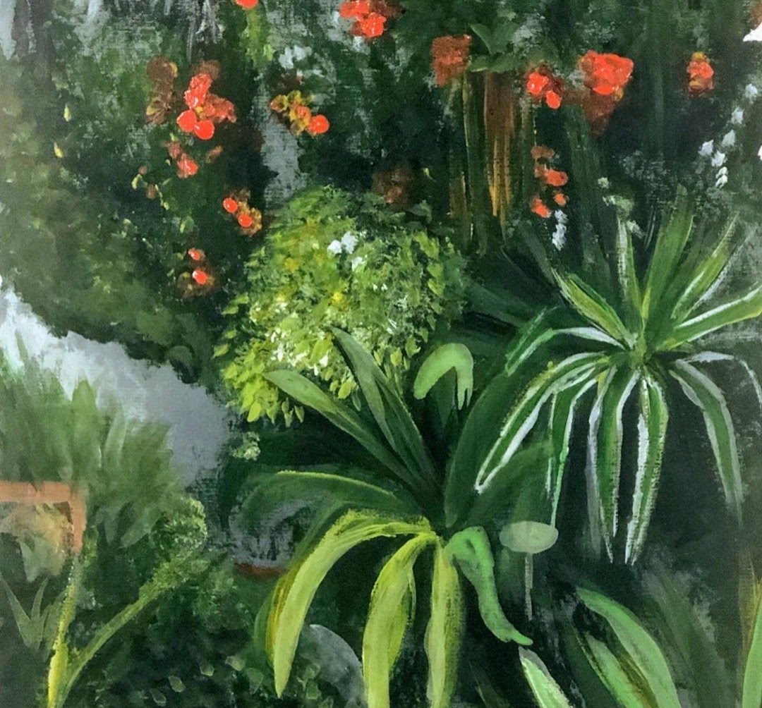 Dense garden foliage with long green leaves and orange blooms