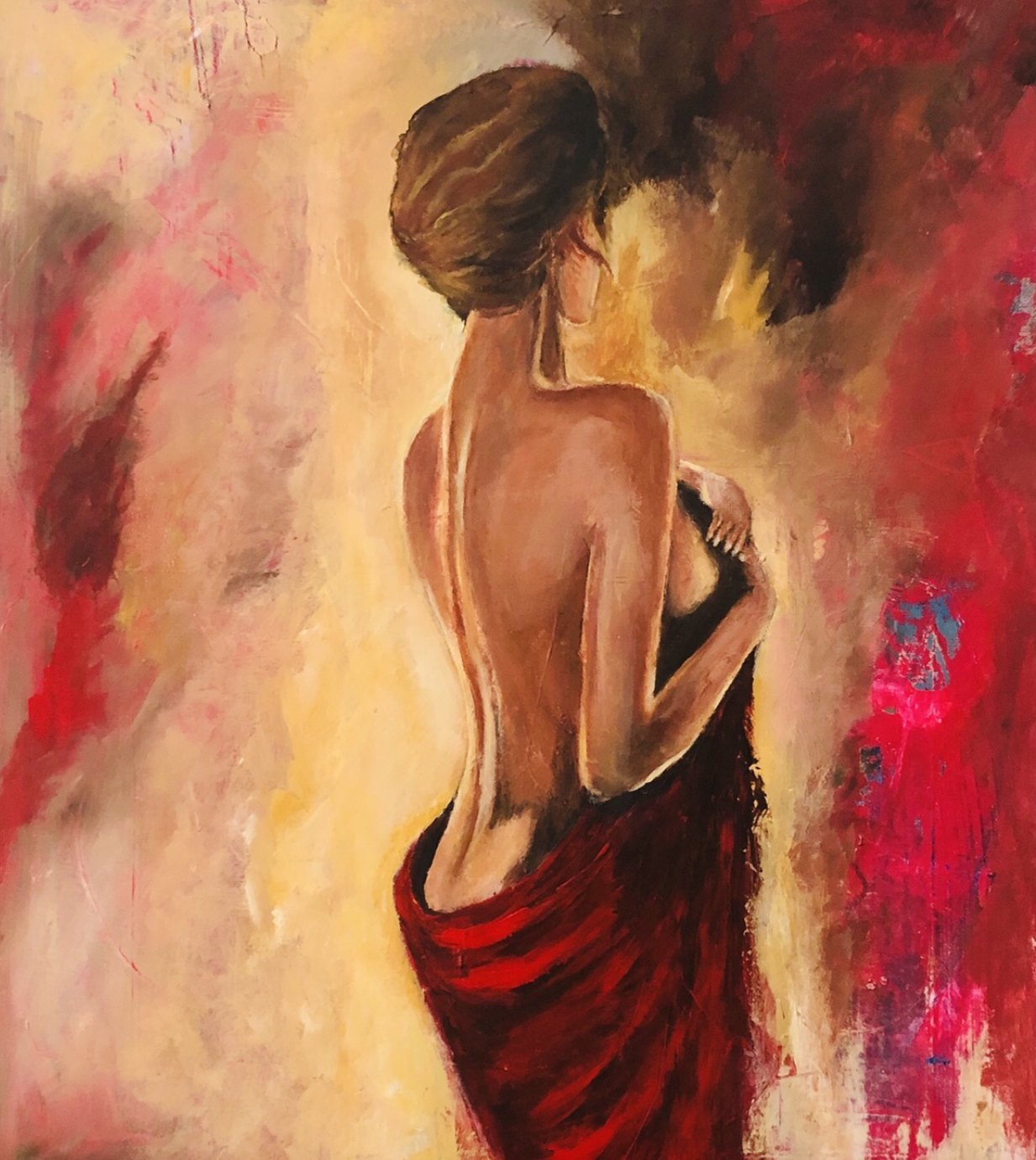 A woman seen from behind, bare-shouldered, wrapped in red cloth
